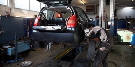 Mekaniker er ved at skifte dæk på en bil